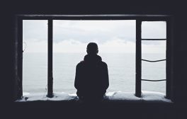 person looking out through window