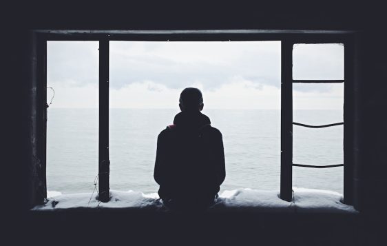 person looking out through window