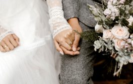 married couple holding hands